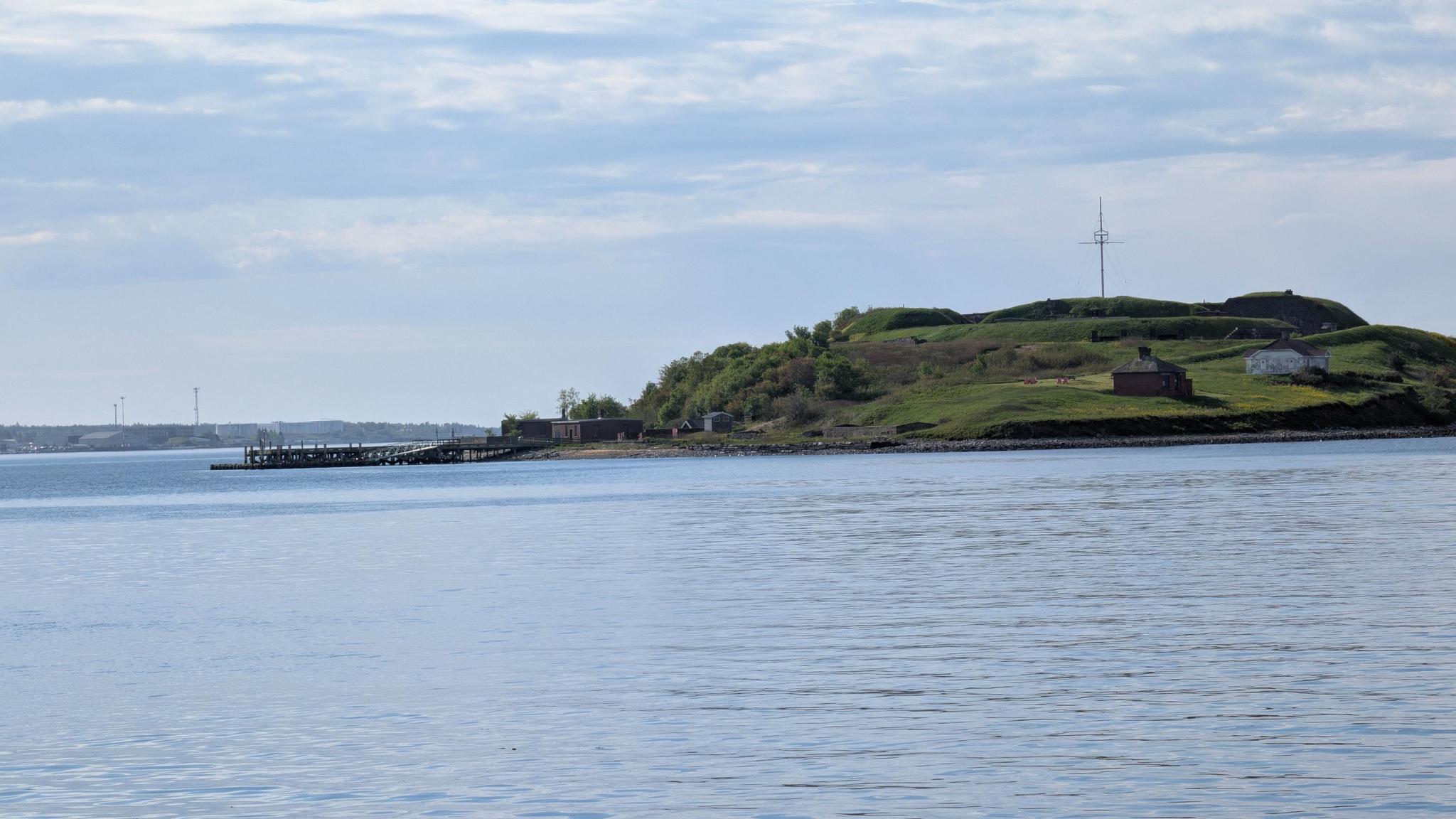 Source image 1 showing Georges Island, dock, calm water, and bright sky.